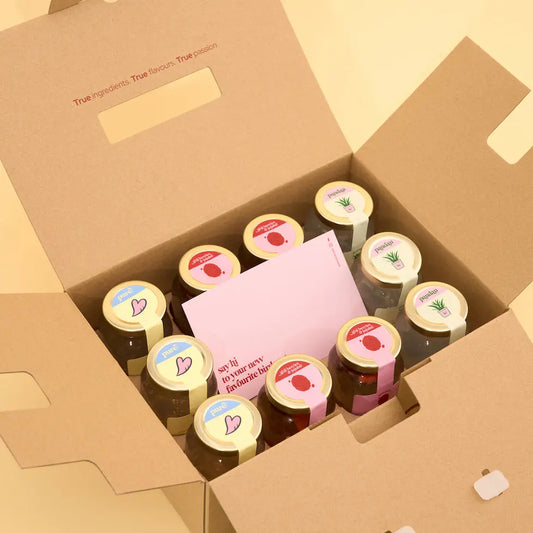 Box of 10 jars freshly boiled birdnest with decorative lids on a yellow background