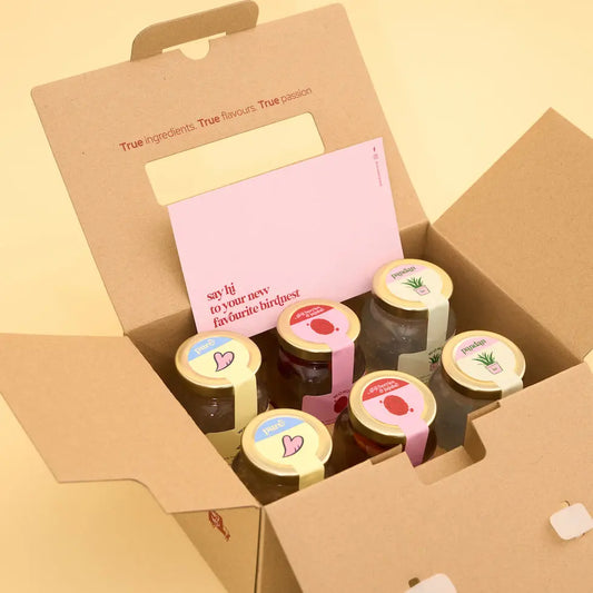 Box of 6 jars freshly boiled birdnest with decorative lids on a yellow background