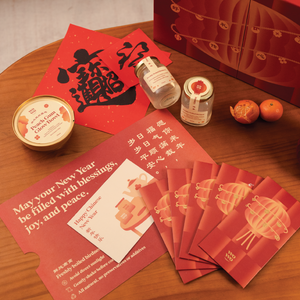 Red envelopes, lanterns, and other New Year's items on a wooden table